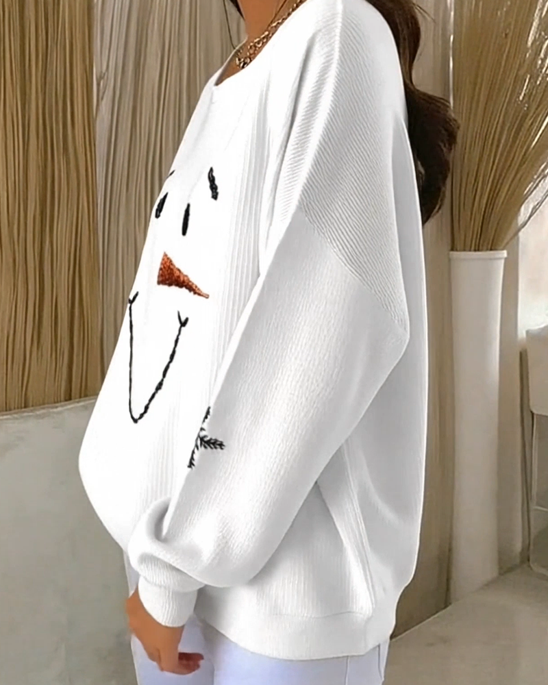 Women's white sweatshirt with a snowman face graphic and snowflake sleeve details
