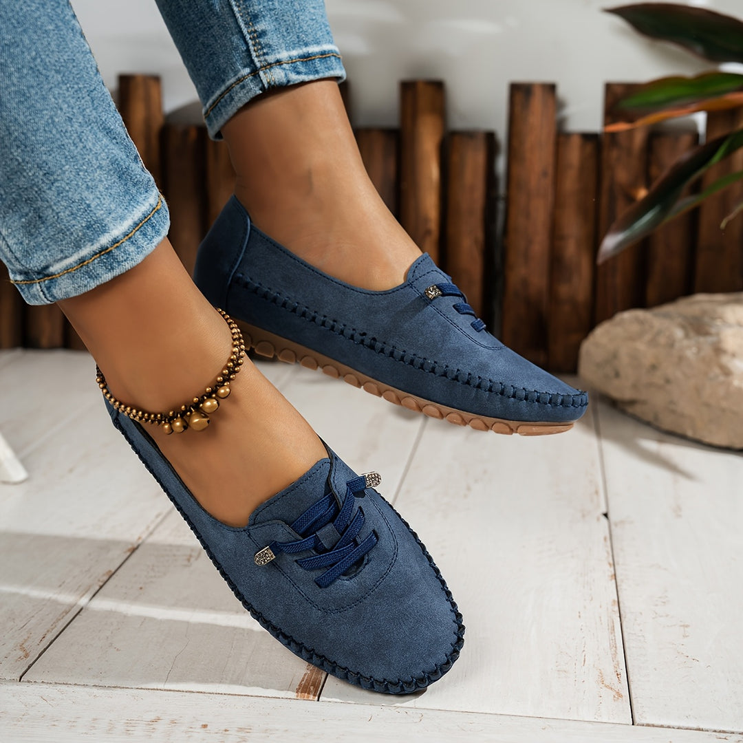 Women's moccasin loafers with lace detail, stitched trim and flat textured soles