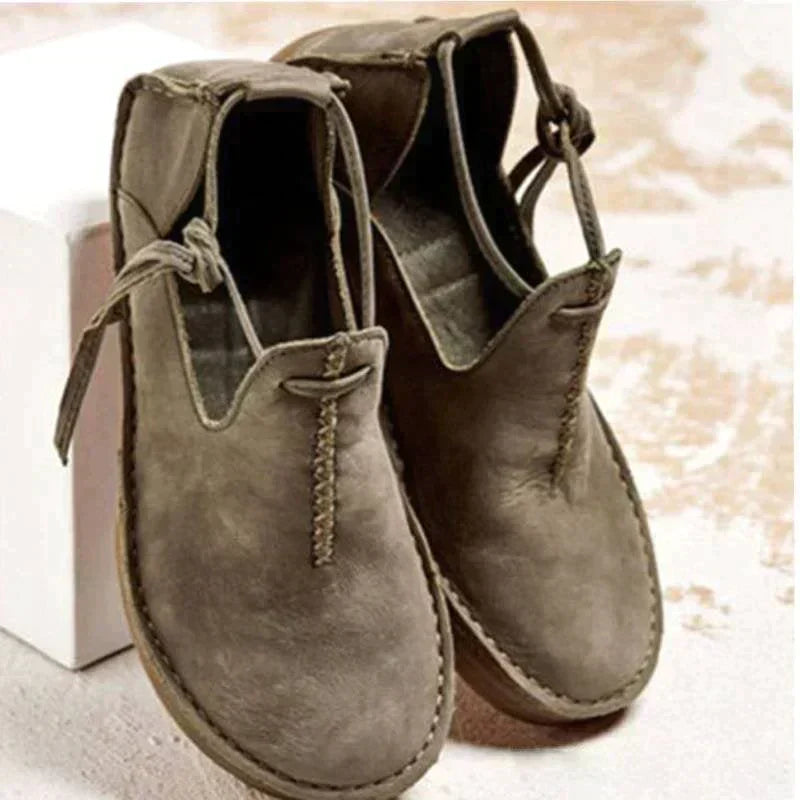 Women's ankle boots with round toes, stitched edging and side ties