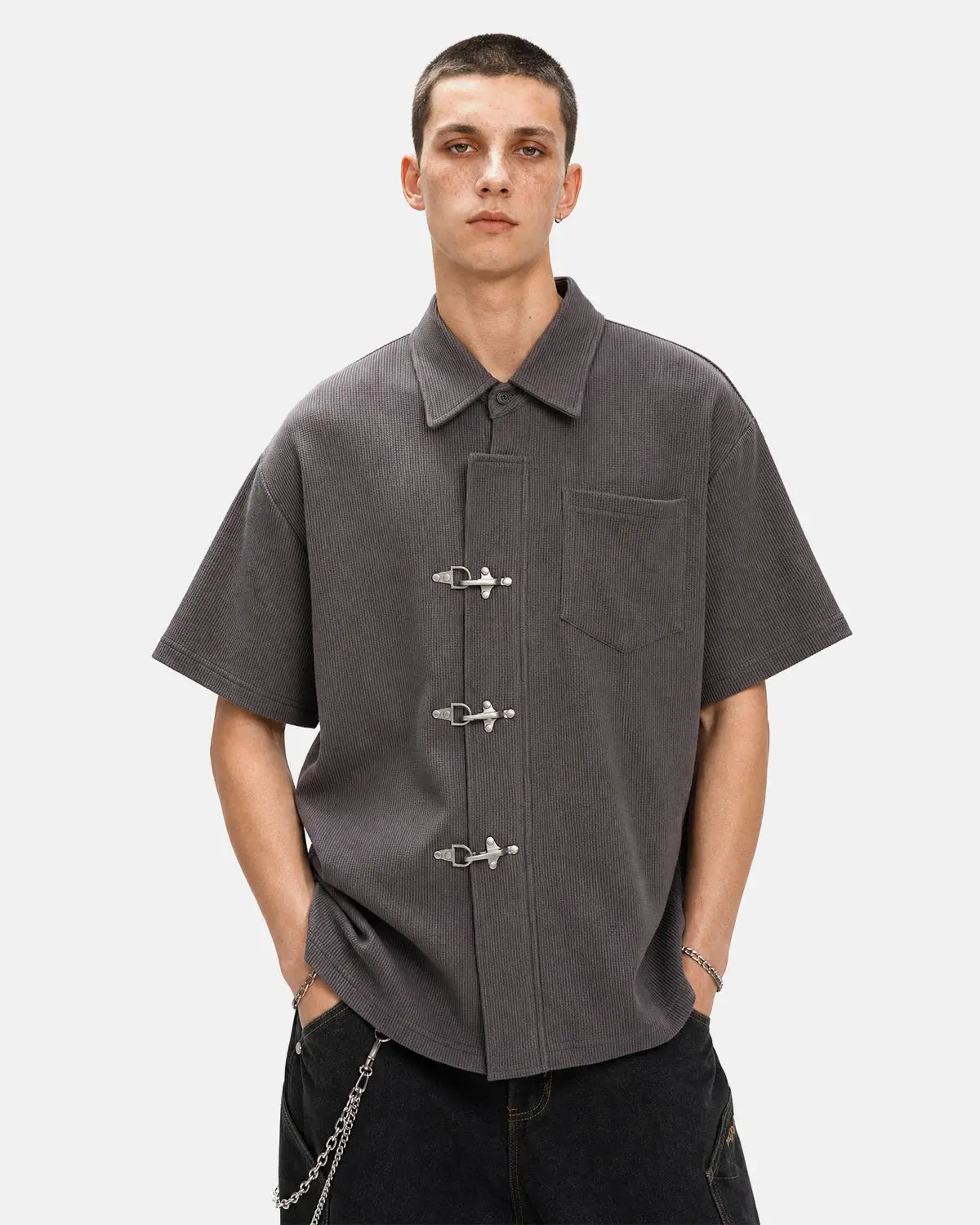 Men's grey waffle-textured short-sleeve shirt with metal clasps and chest pocket
