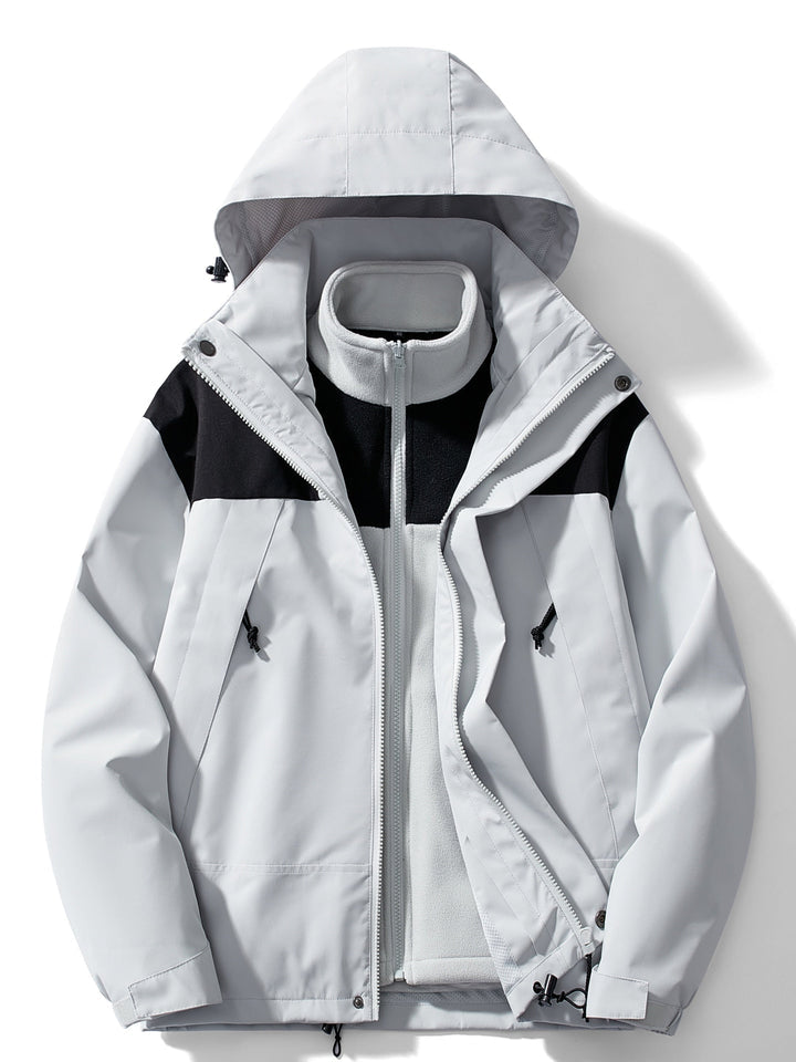 Women's hooded layered outdoor jacket with long sleeves and zipped pockets