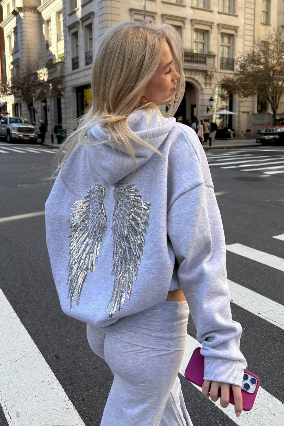 Women's hooded sweatshirt with large sequin wing graphic on the back