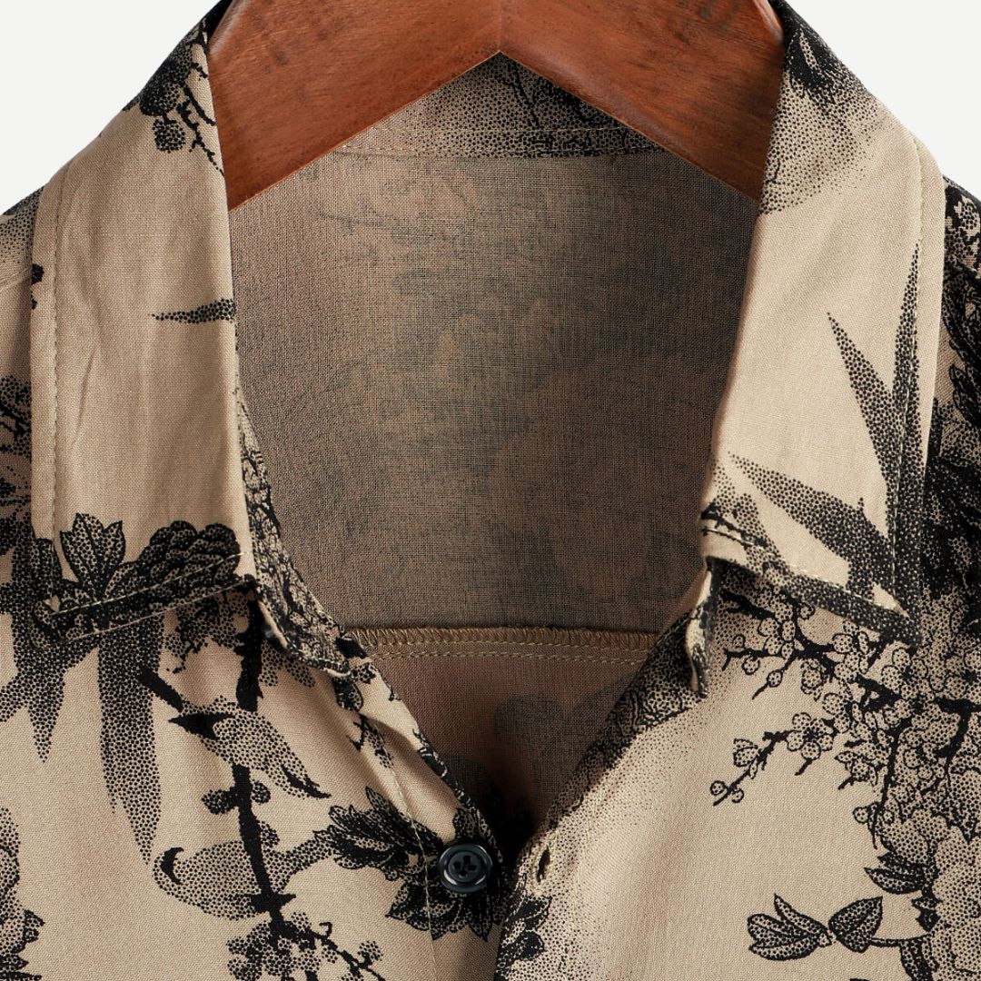 Men's beige short sleeve shirt with black floral print and button front