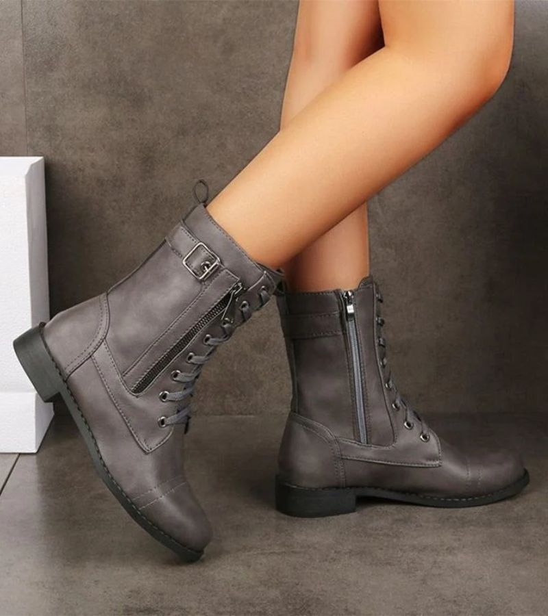 Women's mid-height combat boots with laces, side zip and buckle detail