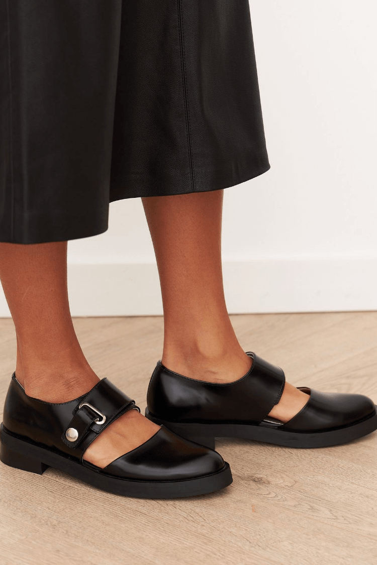Women's black loafers with rounded toes and buckle straps
