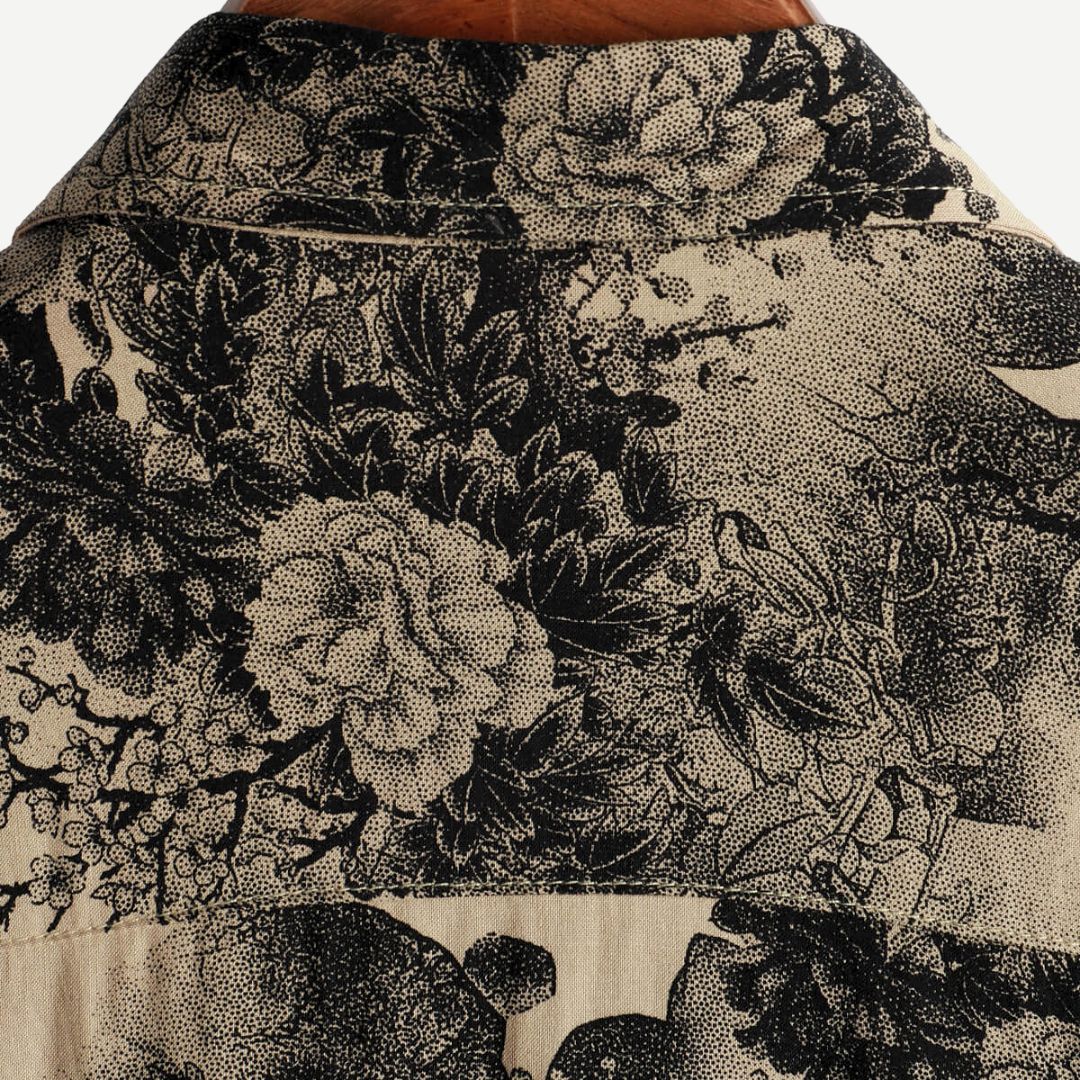 Men's beige short sleeve shirt with black floral print and button front