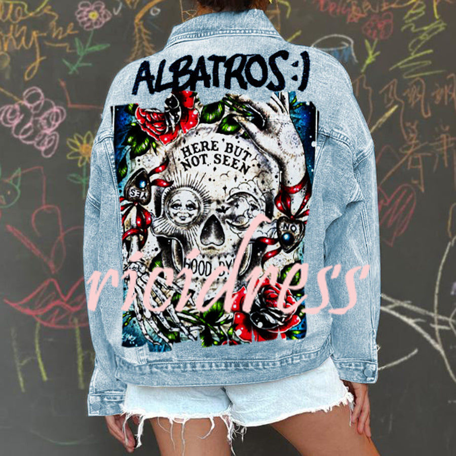Women's light blue denim jacket with a large skull and rose graphic on the back