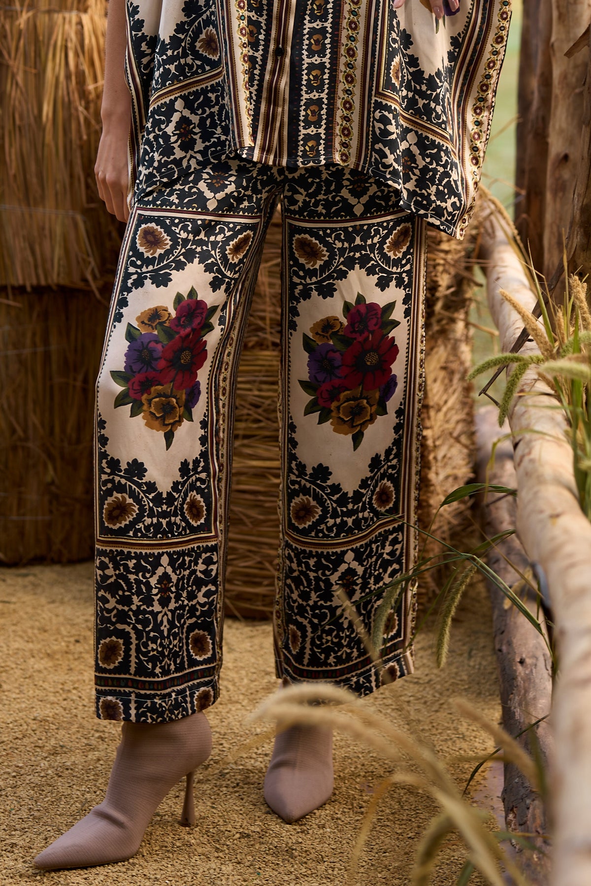 Woman wearing a multicoloured floral printed shirt and straight-cut trousers set