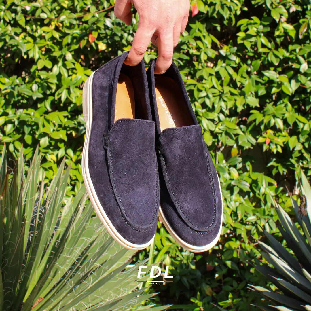 Pair of black men's slip-on loafers with contrasting flat soles