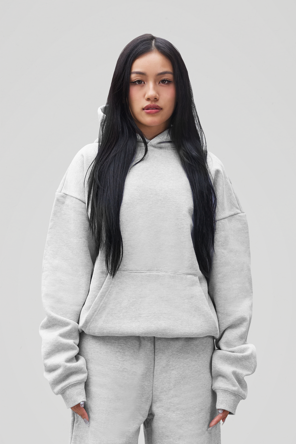 Grey pullover hoodie with hood, long sleeves and front kangaroo pocket