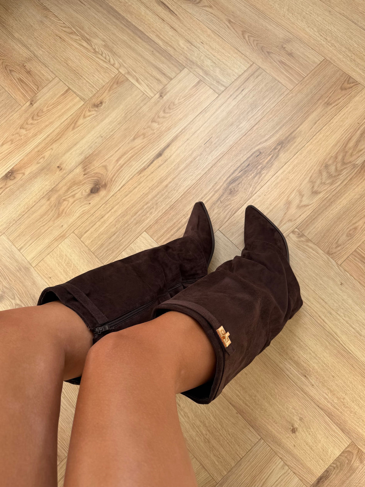 Women's brown knee-high boots with pointed toes, low block heels and buckle strap detail