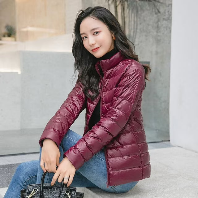Women's quilted puffer jacket with high collar and zip front