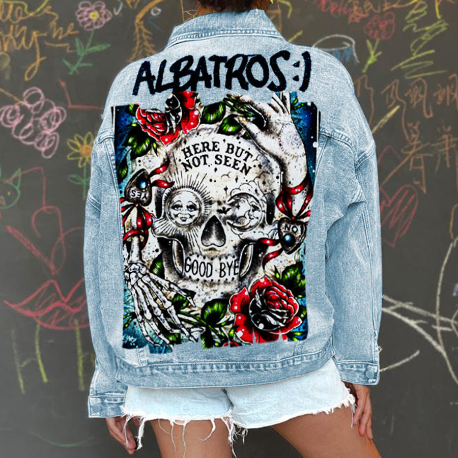 Women's light blue denim jacket with a large skull and rose graphic on the back