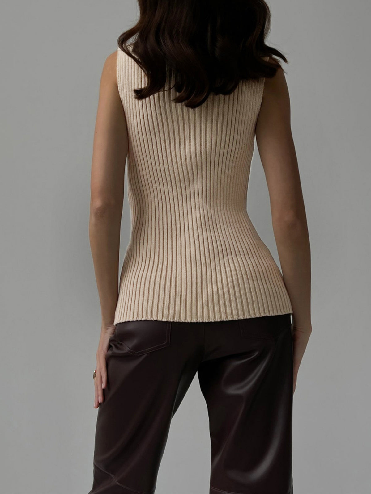 Women's ribbed sleeveless knit top with high neckline and fitted shape