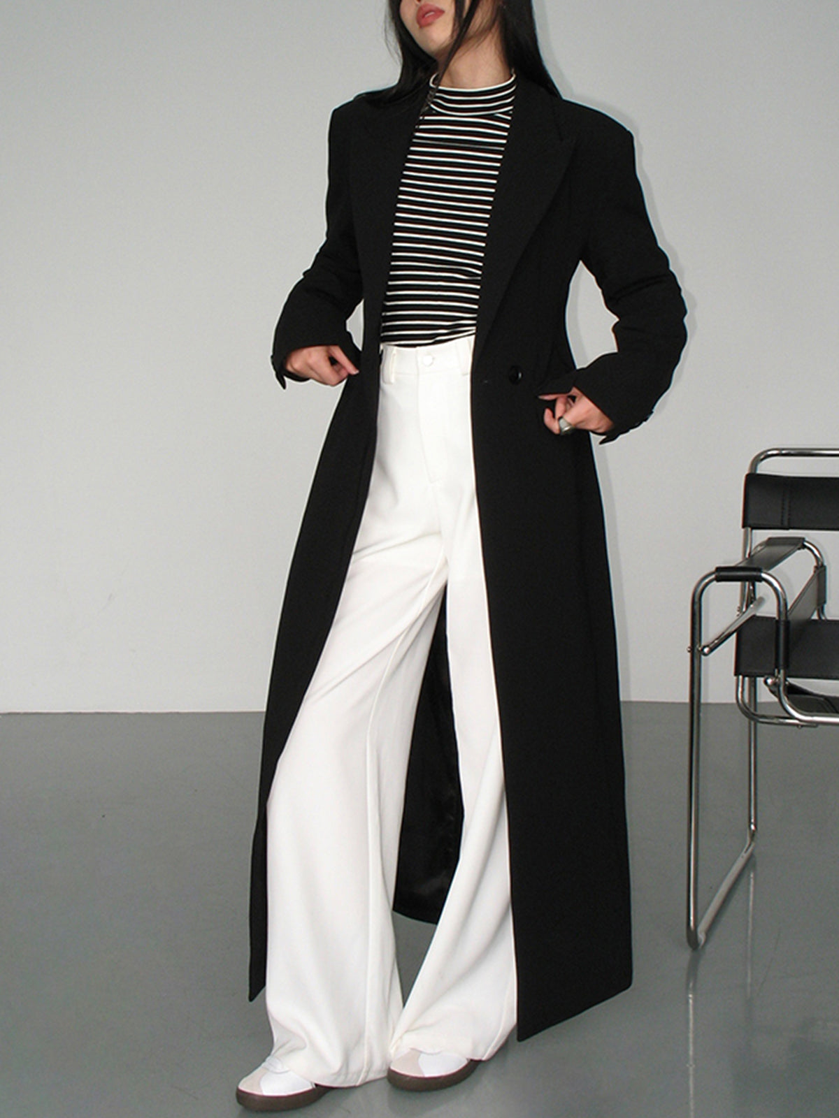 Women's black long tailored coat with lapels and one-button closure
