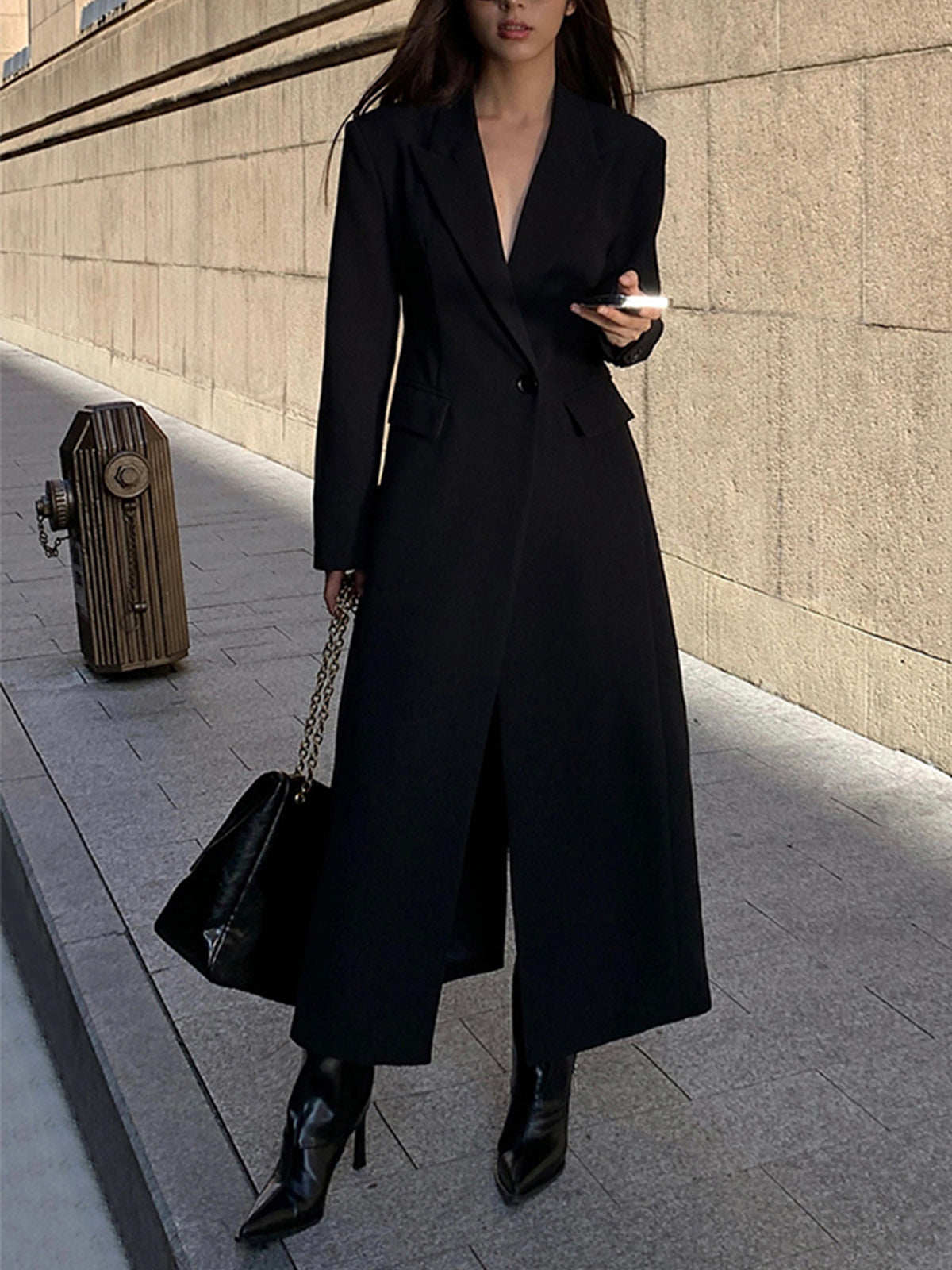 Women's black long tailored coat with lapels and one-button closure
