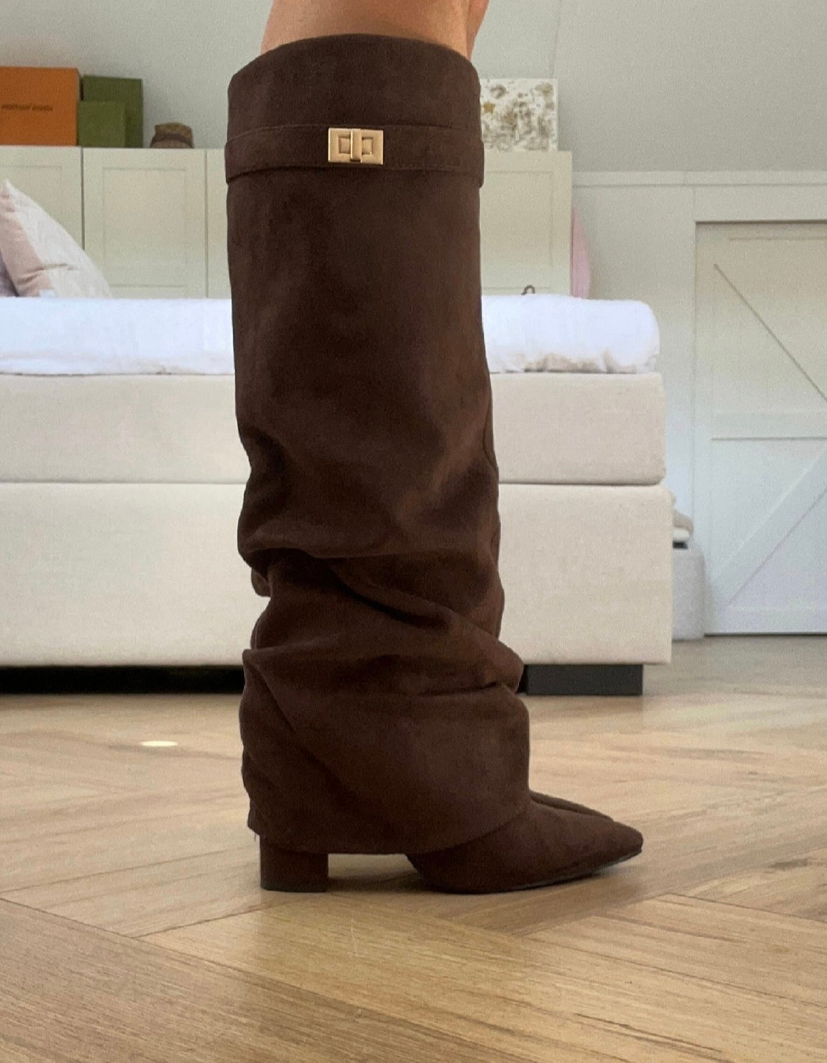 Women's brown slouch knee-high boots with pointed toes, low block heels and buckle detail