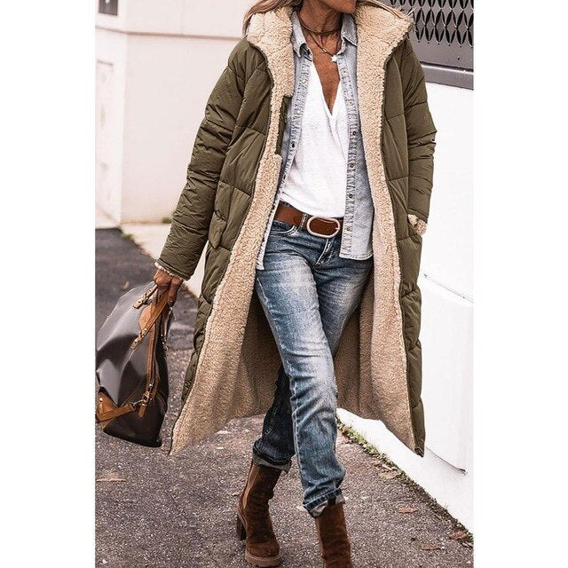 Woman wearing a long hooded quilted puffer coat with contrasting textured trim