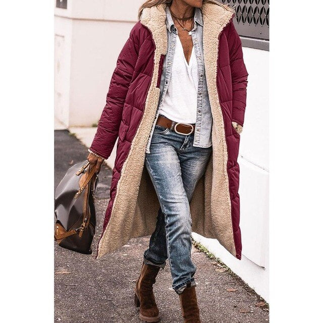 Woman wearing a long hooded quilted puffer coat with contrasting textured trim