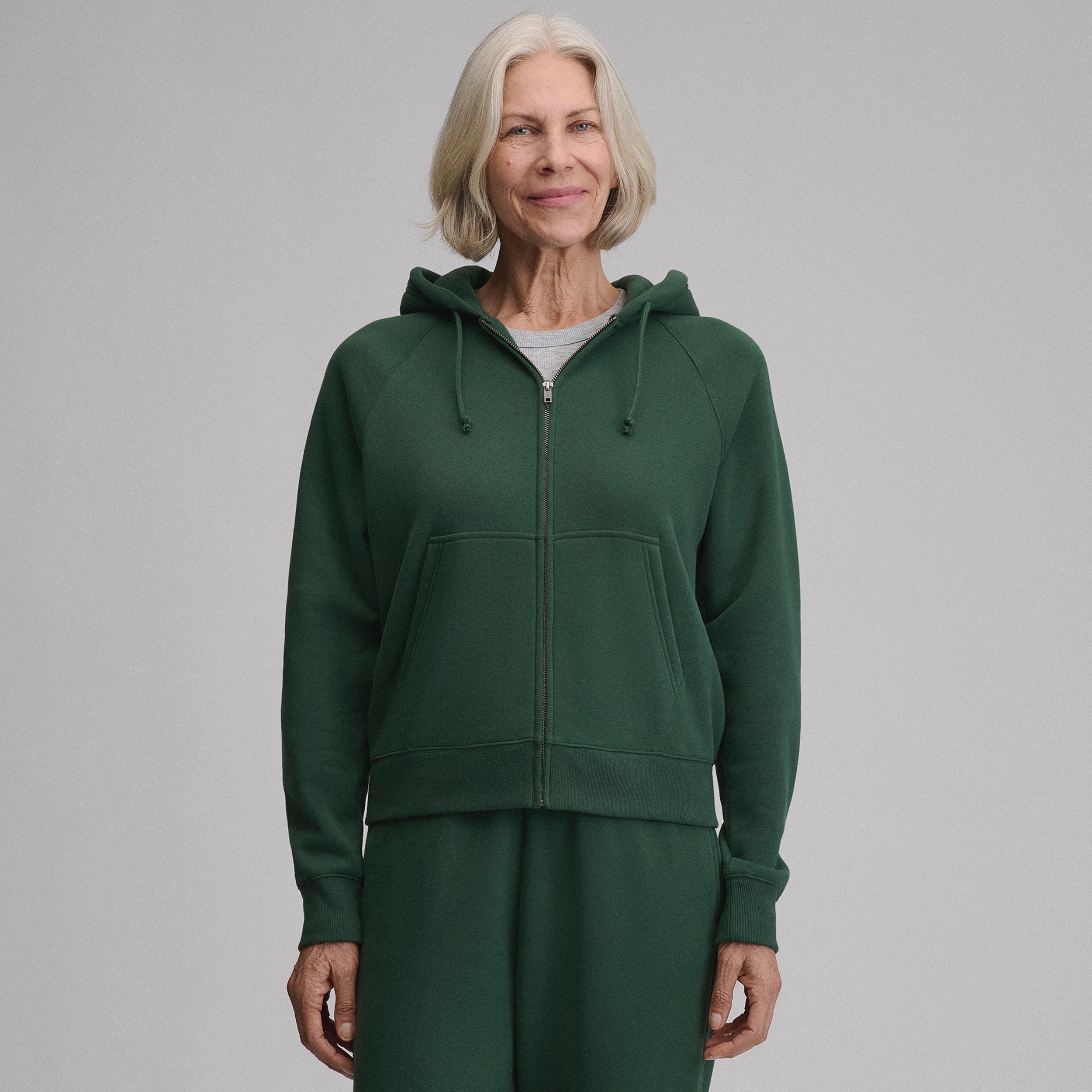 Women's full-zip hooded sweatshirt with long sleeves and front pouch pockets