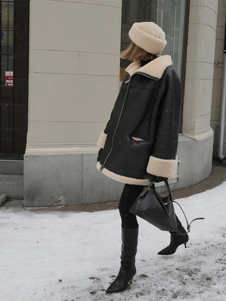Women's black oversized jacket with cream shearling-style trim and zip front