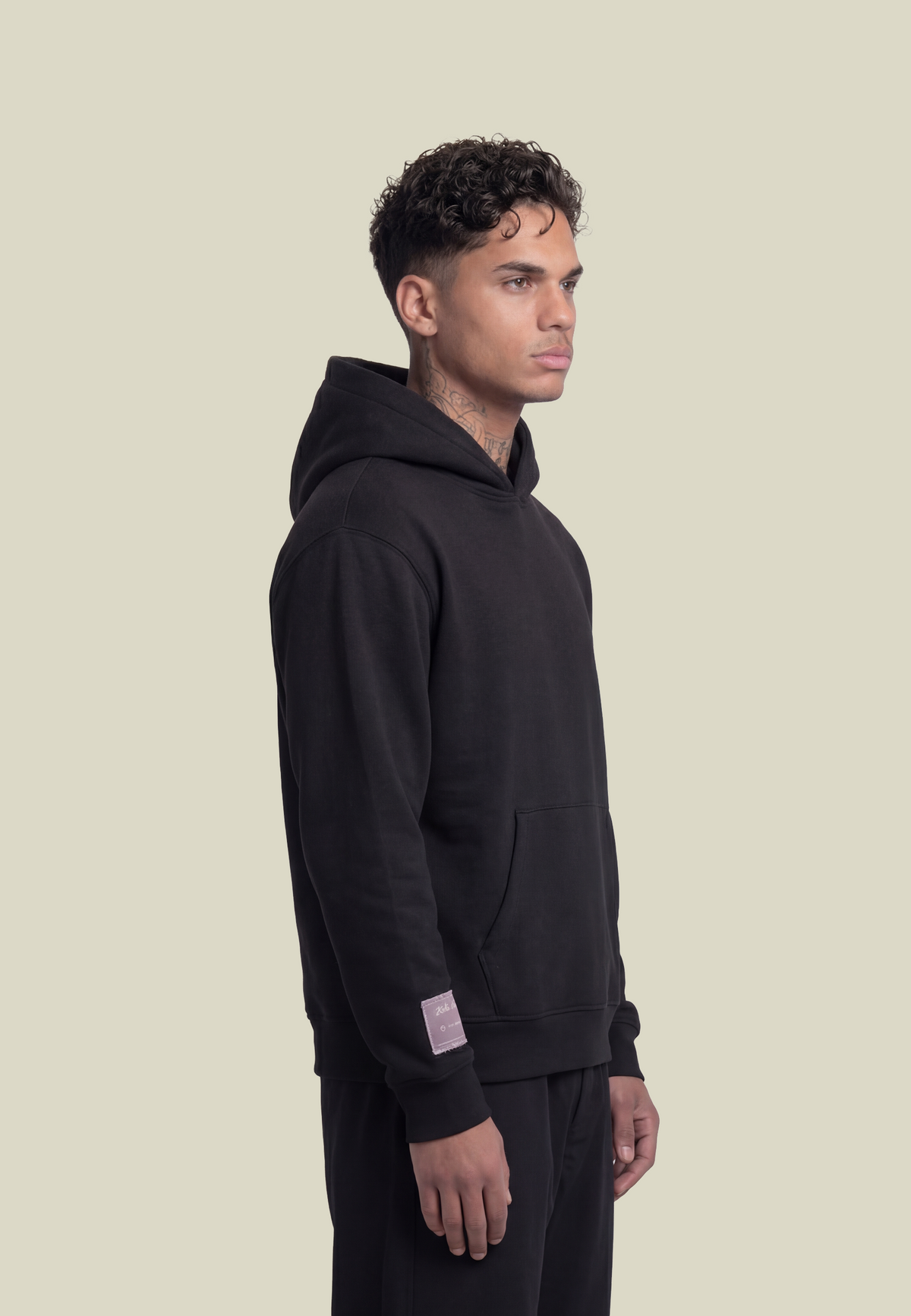 Black hooded sweatshirt with white script sleeve detailing and kangaroo pocket