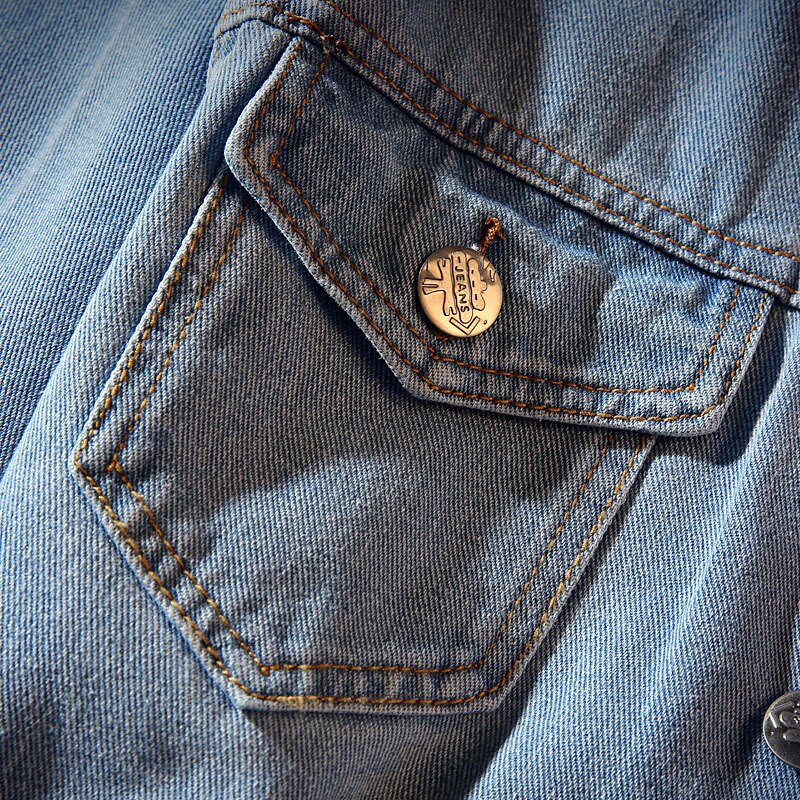 Men's blue denim jacket with stand collar, button front and chest pockets