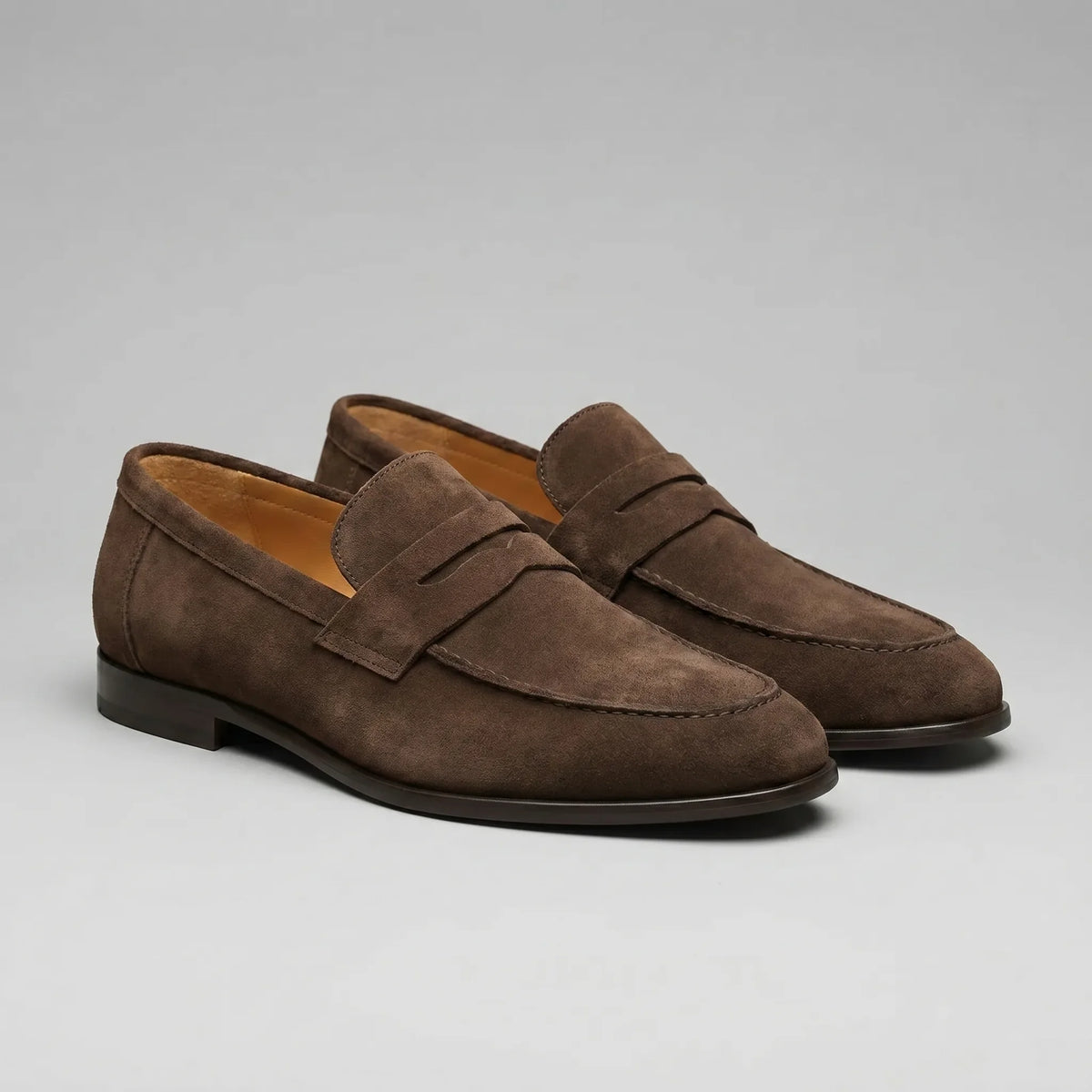 Men's penny loafers with closed backs, raised vamp straps and low flat heels