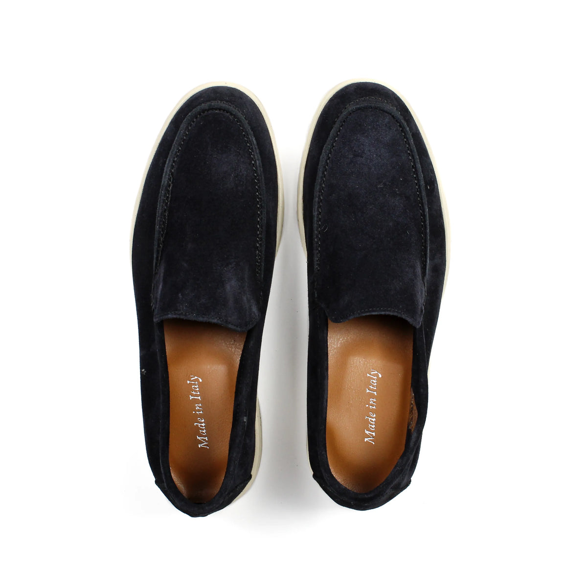 Pair of black men's slip-on loafers with contrasting flat soles