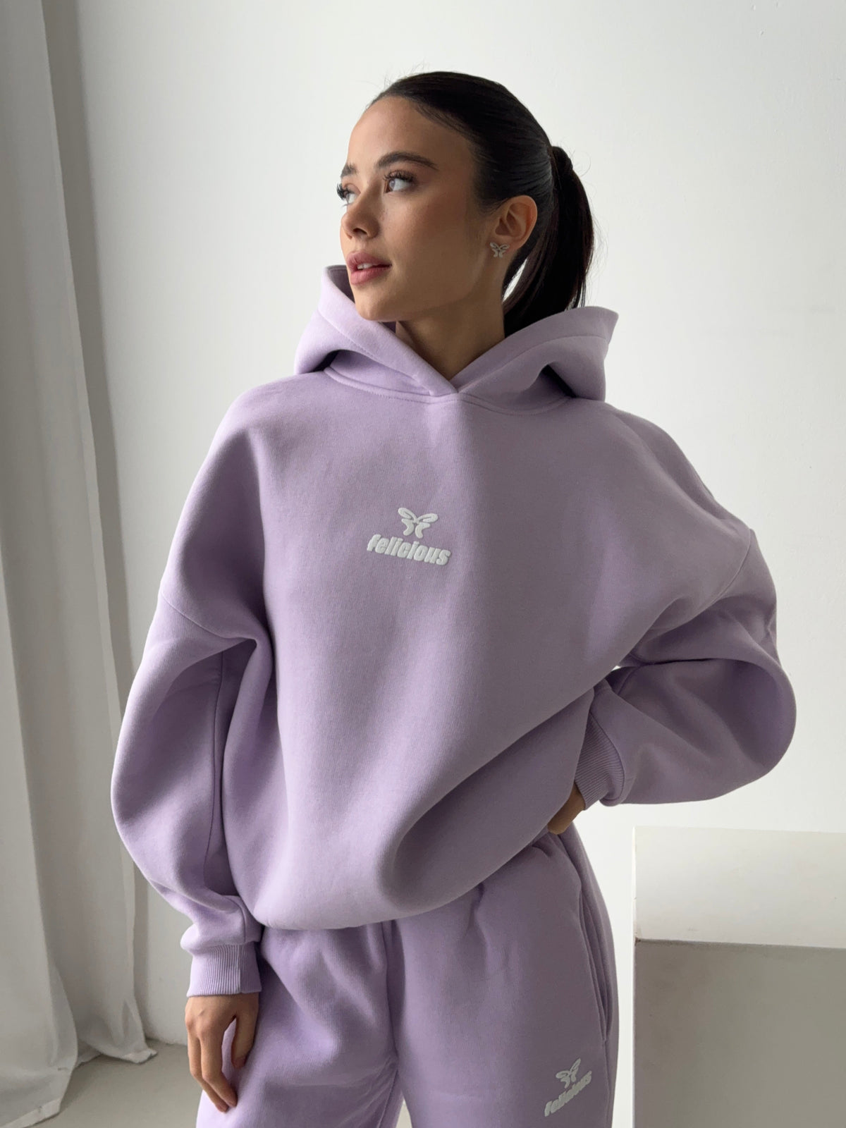 Women's lavender hooded sweatshirt with white butterfly logo and ribbed trims