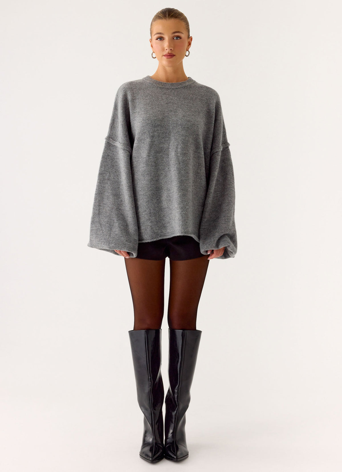 Women's grey oversized knit sweater with crew neck and flared sleeves
