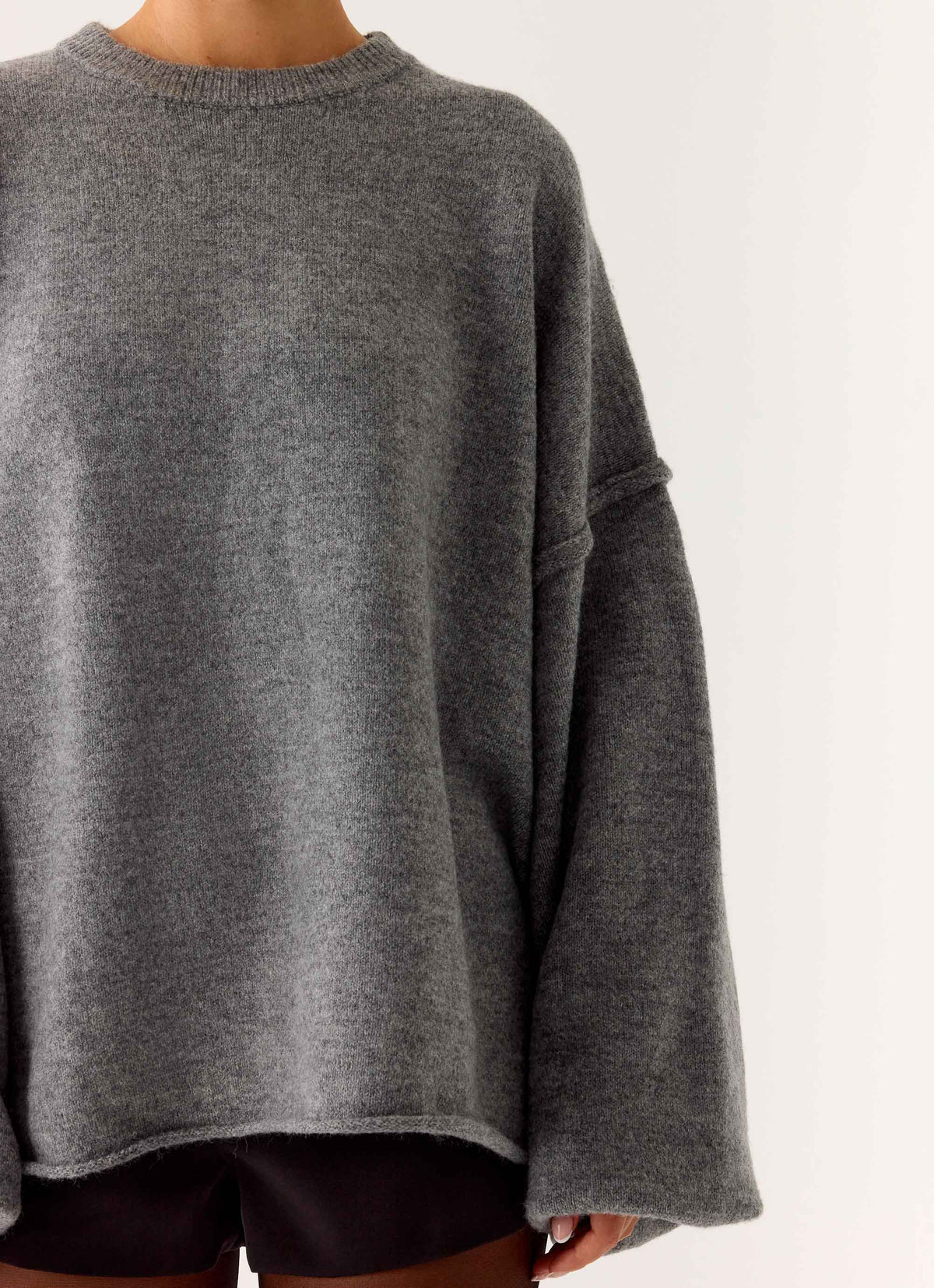 Women's grey oversized knit sweater with crew neck and flared sleeves