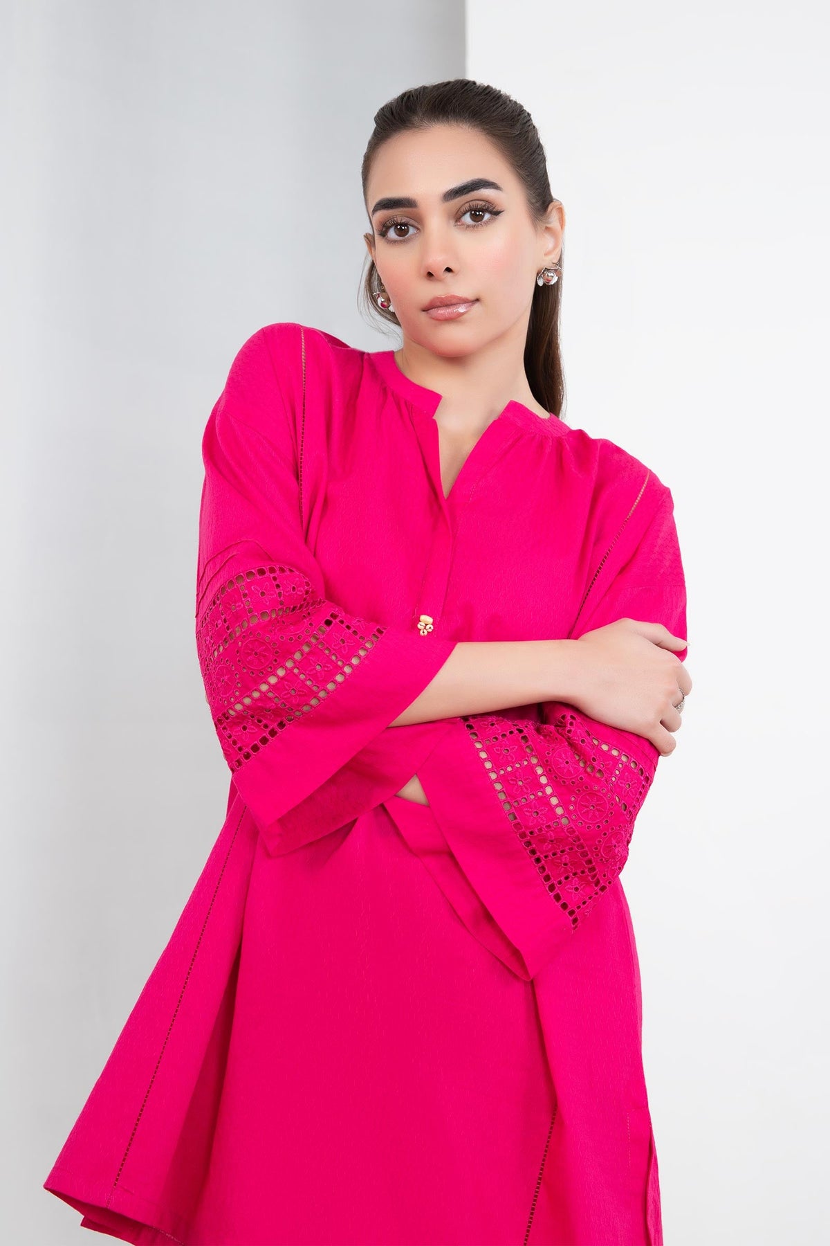Women's bright pink two-piece tunic suit with lace-trimmed sleeves and matching trousers