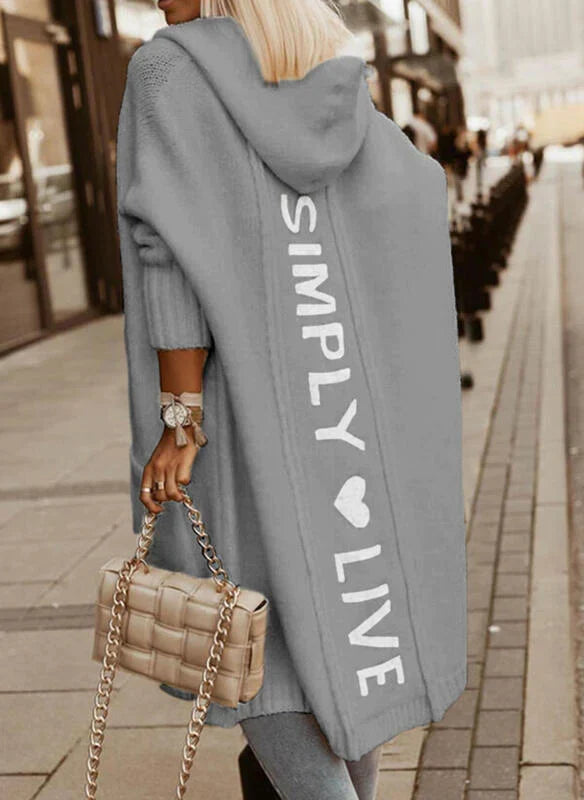 Women's longline hooded knitted cardigan with graphic text on the back