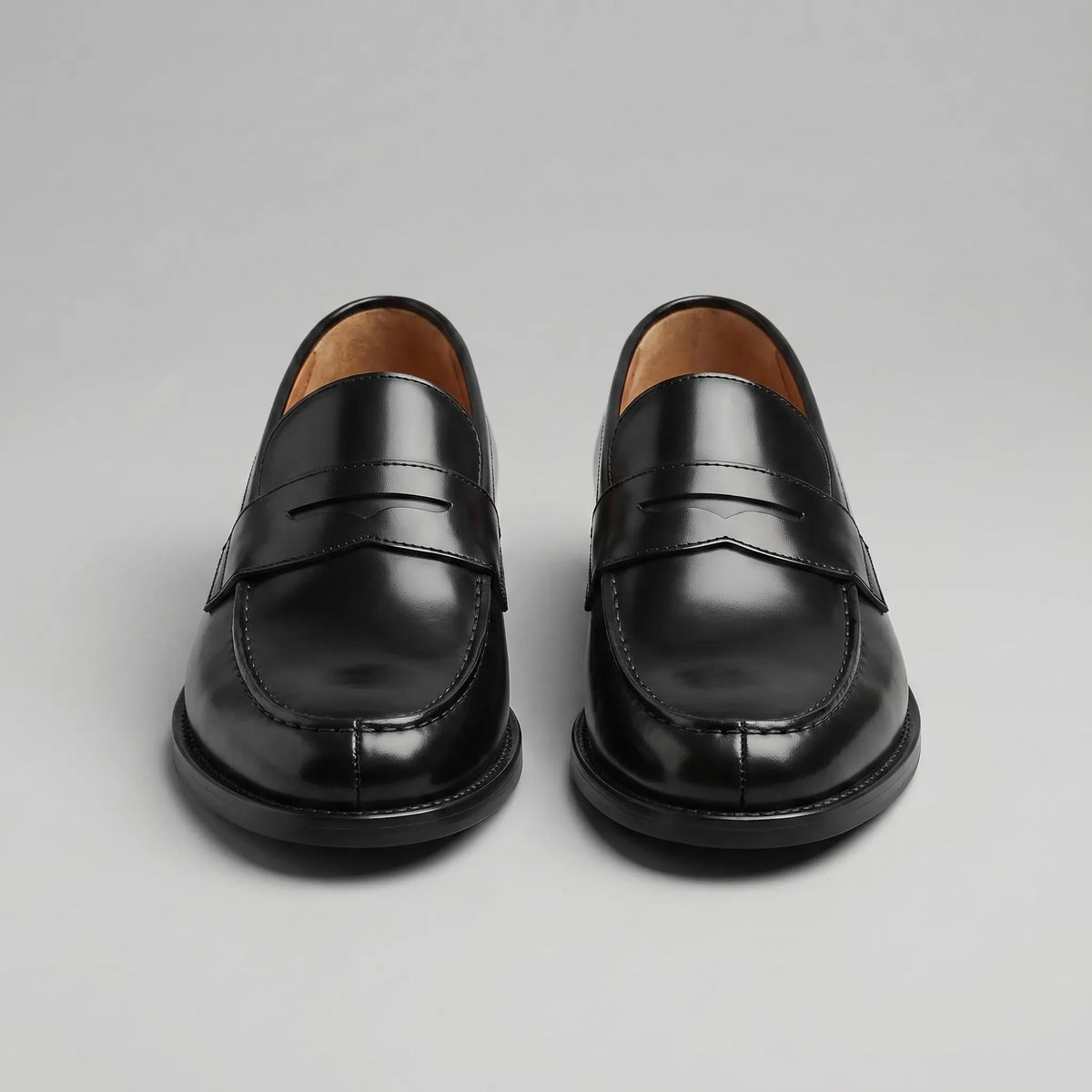 Men's black penny loafers with polished finish and low block heels