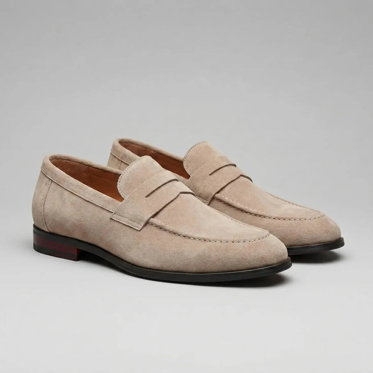 Men's penny loafers with closed backs, raised vamp straps and low flat heels