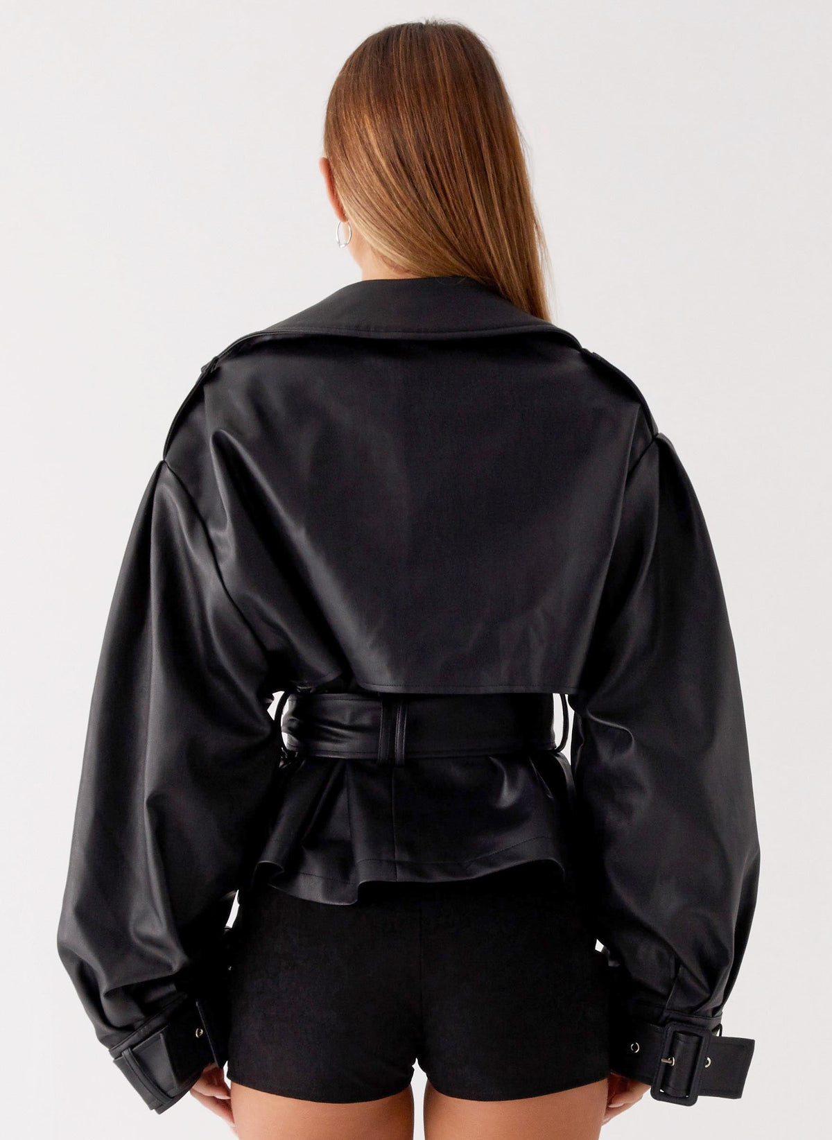 Women's black belted trench jacket with wide lapels and long sleeves
