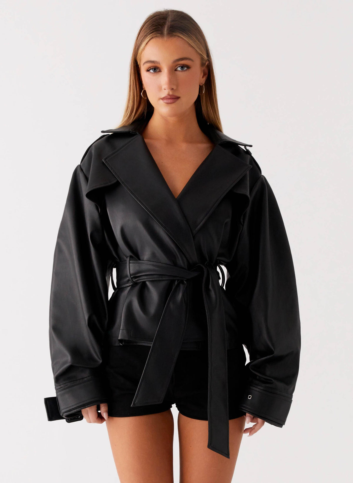 Women's black belted trench jacket with wide lapels and long sleeves