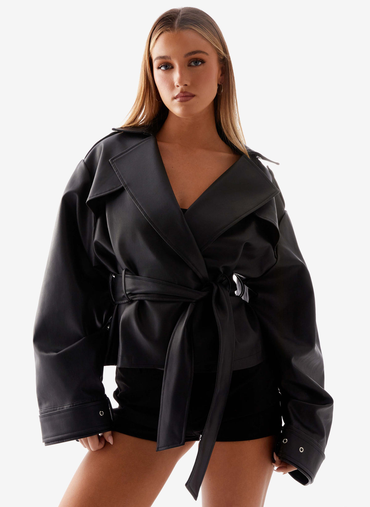 Women's black belted trench jacket with wide lapels and long sleeves