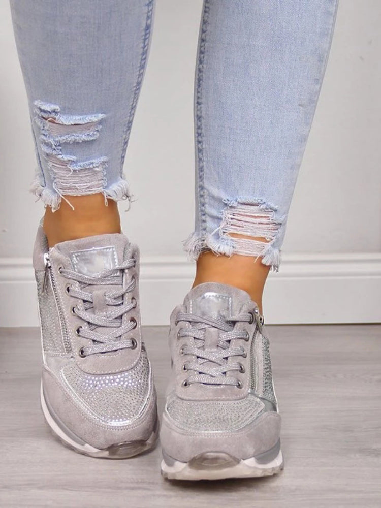 Women's low-top lace-up sneakers with metallic panel details and raised soles