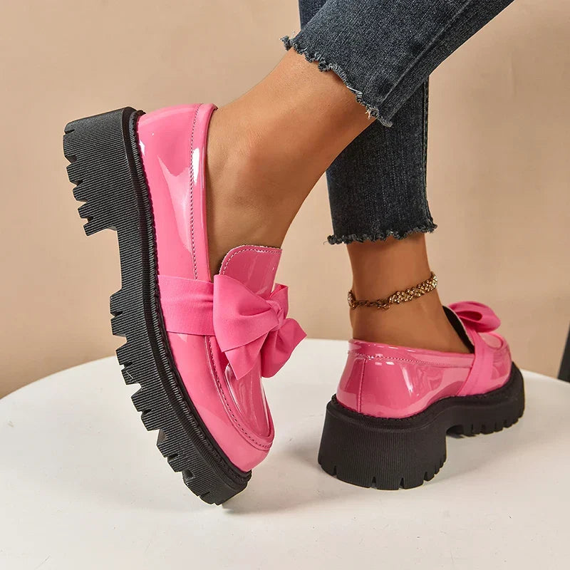 Women's glossy chunky loafers with large bows and black lug soles