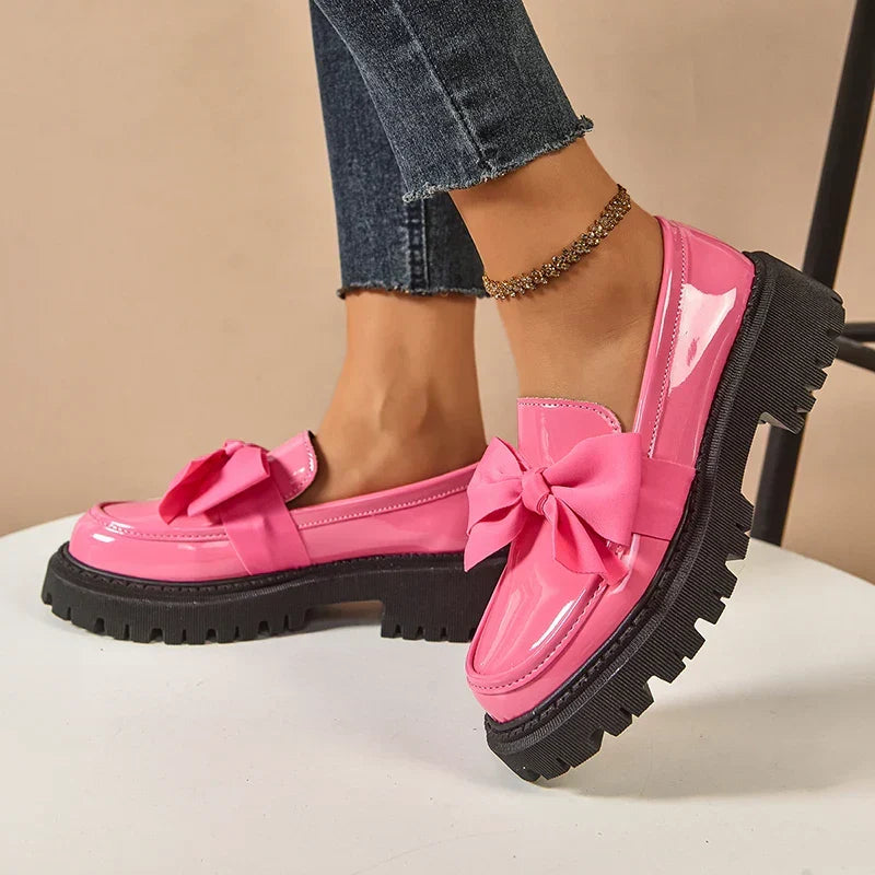 Women's glossy chunky loafers with large bows and black lug soles