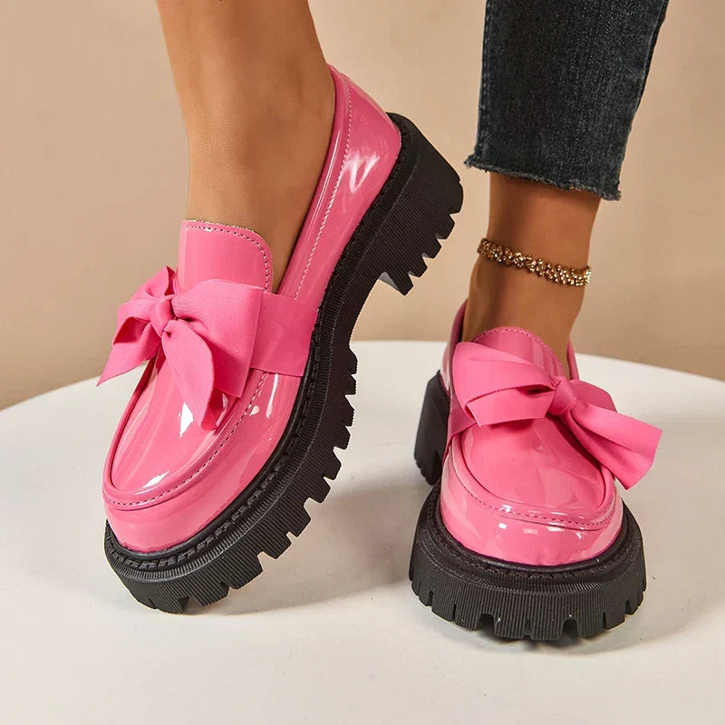 Women's glossy chunky loafers with large bows and black lug soles