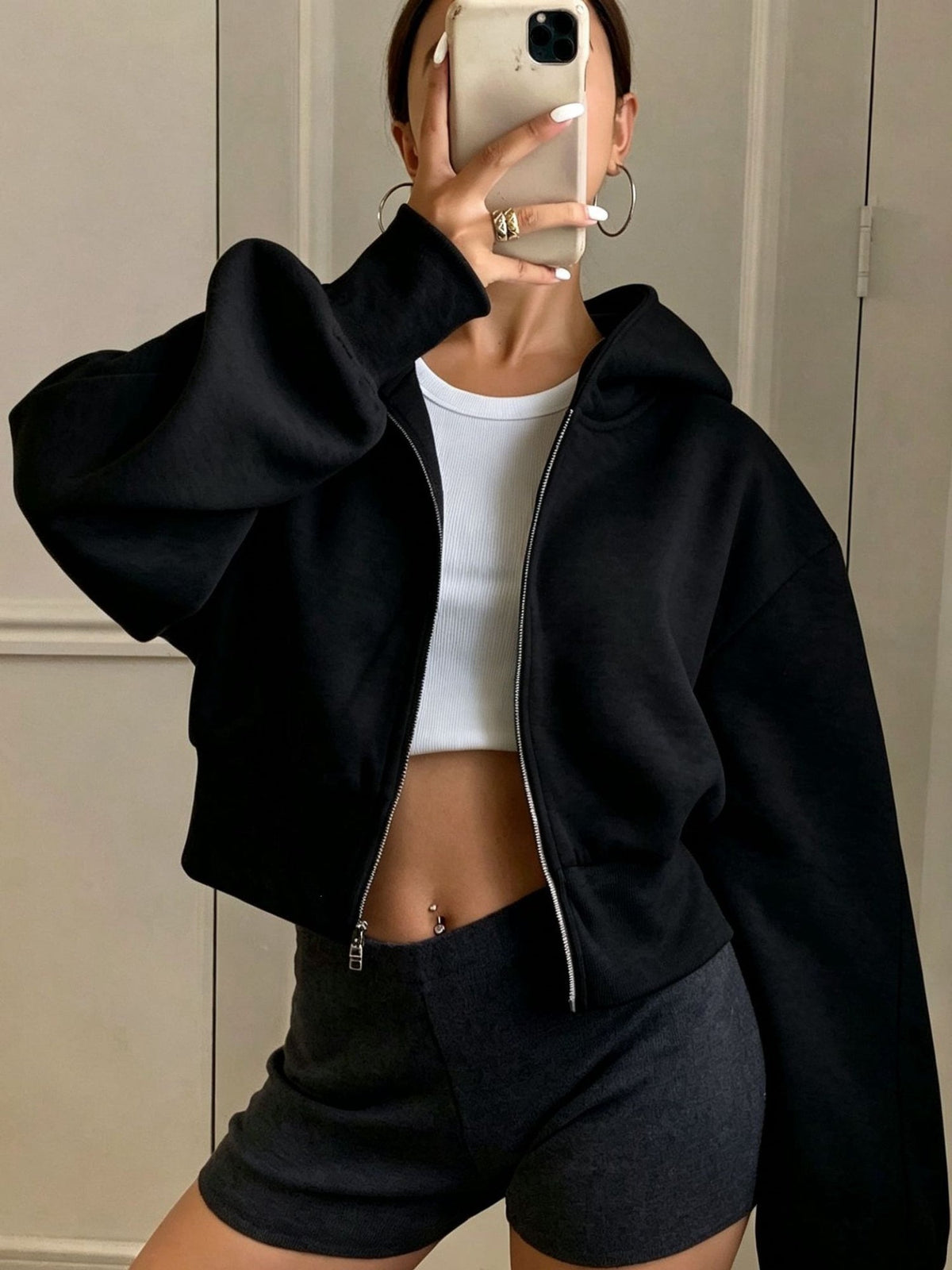 Women's oversized cropped black hooded jacket with long sleeves and front zip