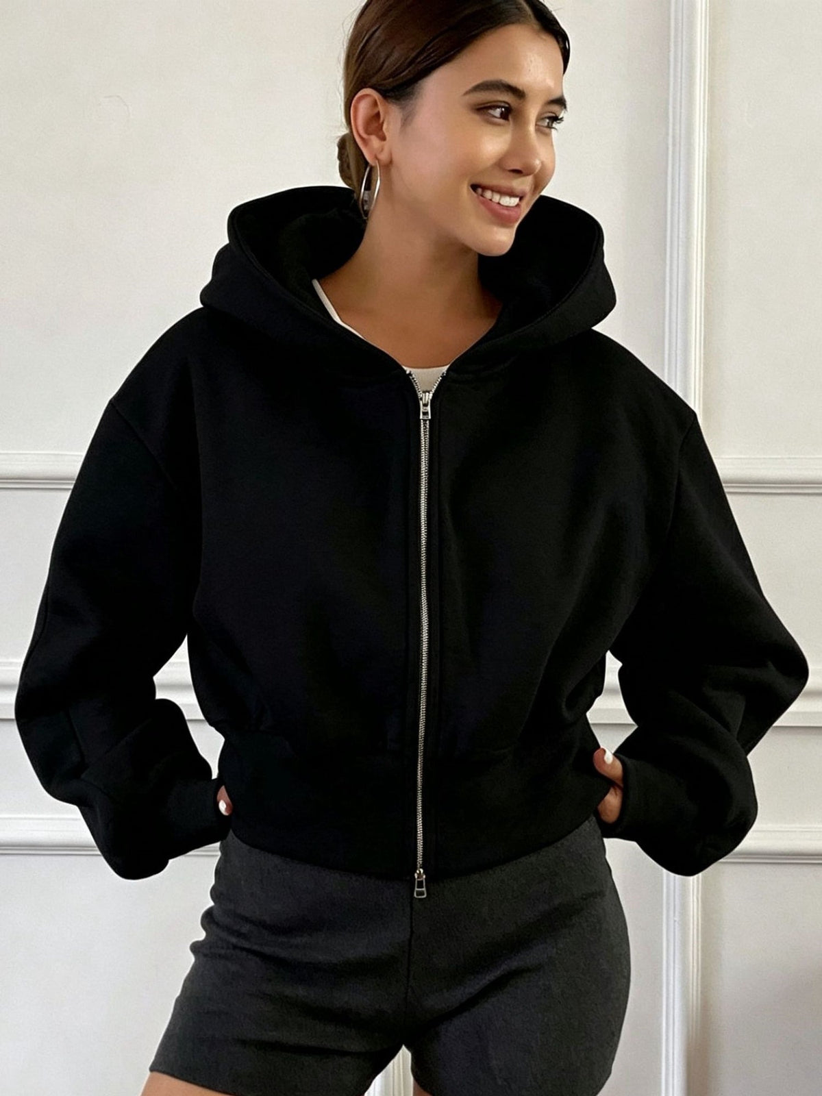 Women's oversized cropped black hooded jacket with long sleeves and front zip