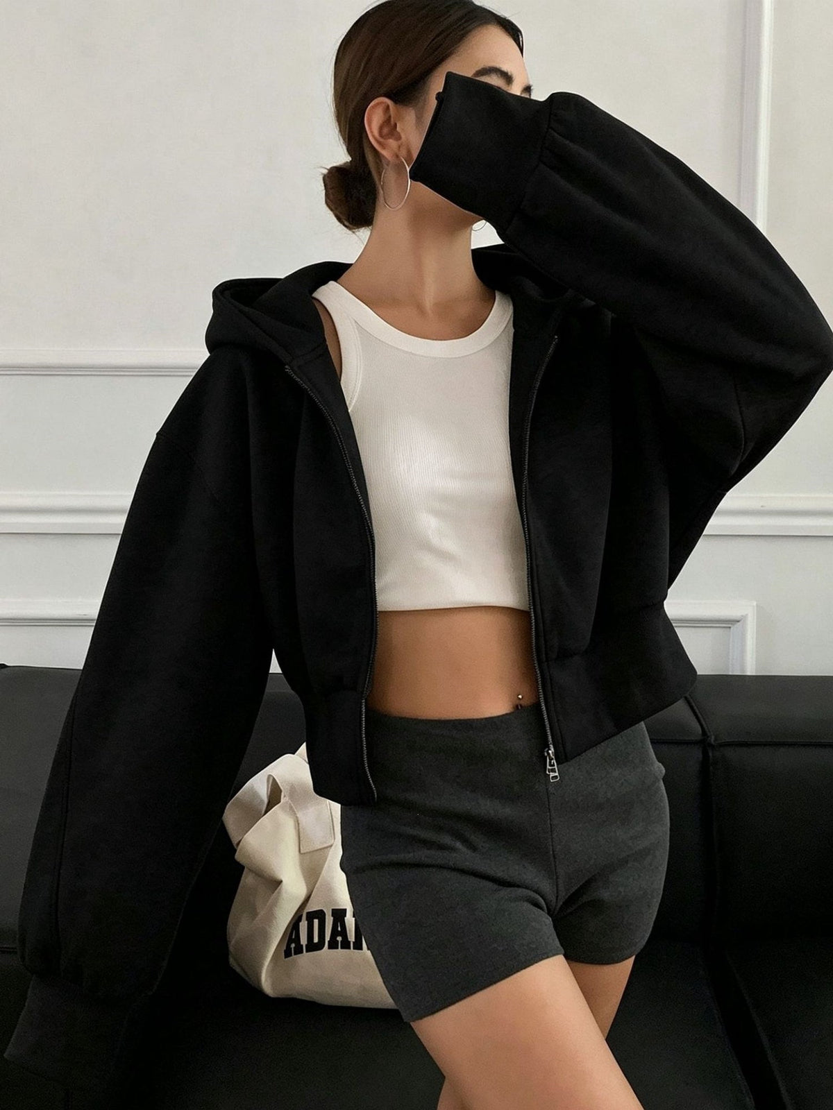 Women's oversized cropped black hooded jacket with long sleeves and front zip
