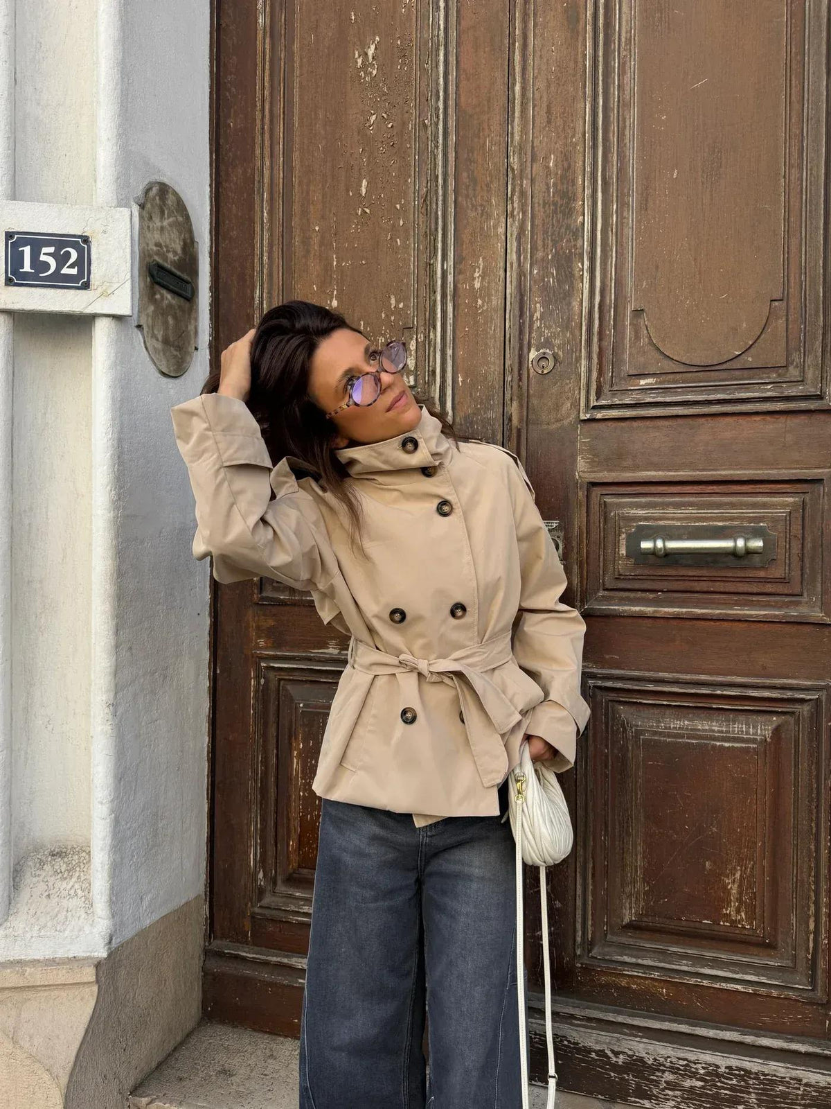 Women's belted button-front trench jacket with high collar and long sleeves