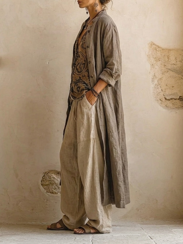 Woman wearing a beige three-piece outfit with printed V-neck top, long cardigan and wide-leg trousers