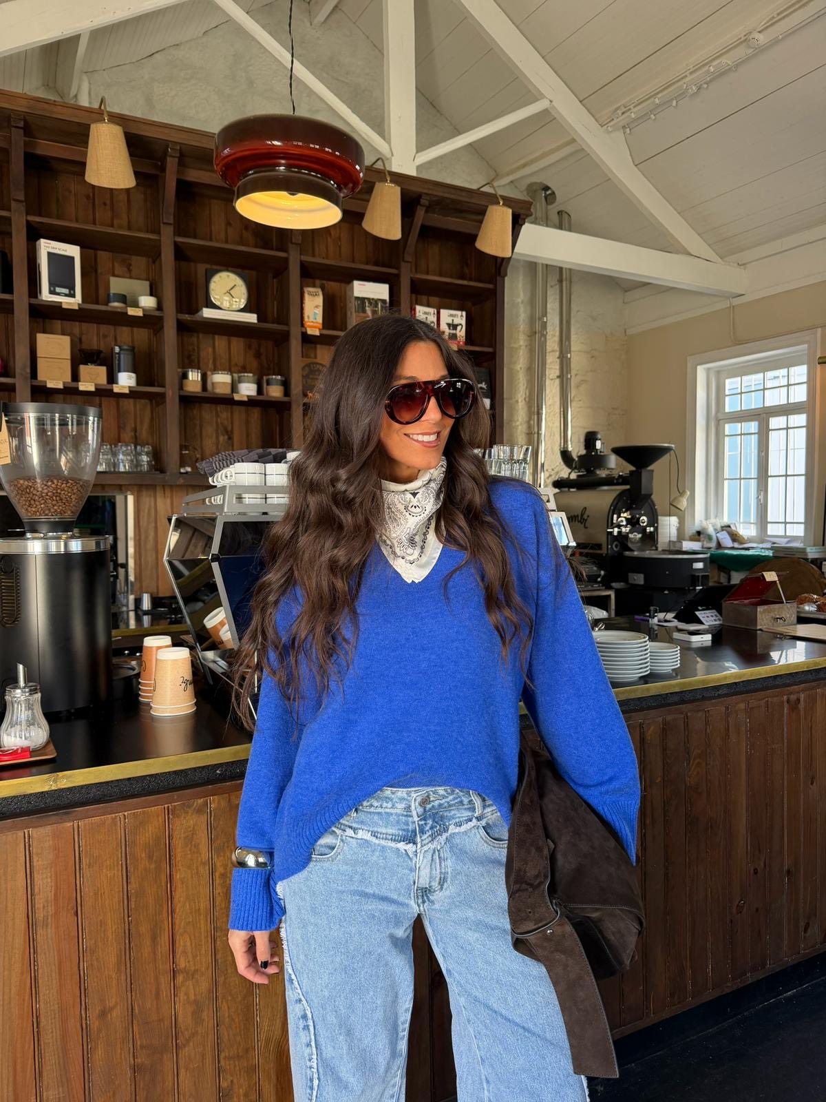 Women's blue V-neck knit sweater with long sleeves and ribbed trims