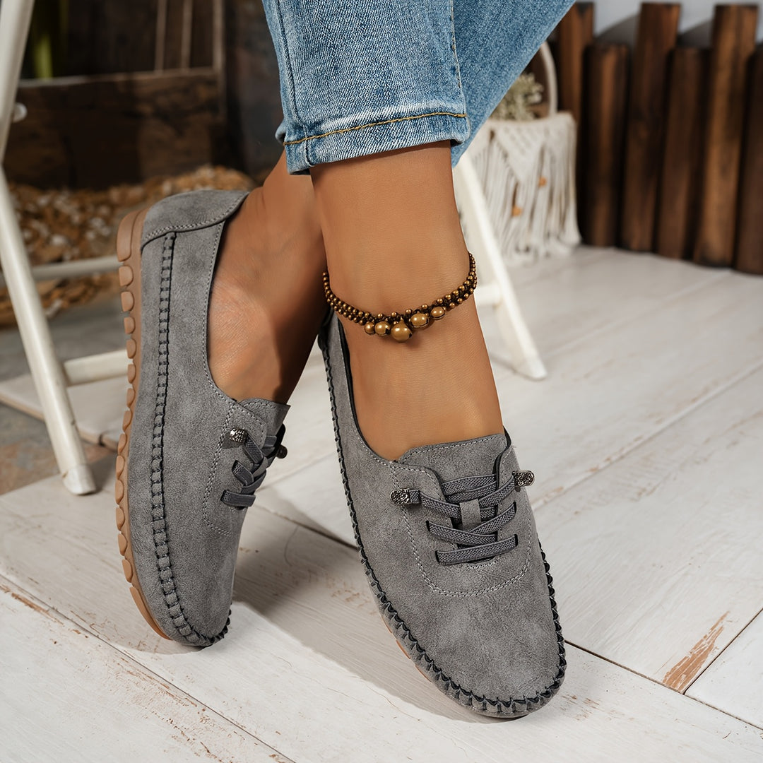 Women's moccasin loafers with lace detail, stitched trim and flat textured soles